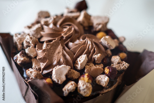 Bild auf Leinwand Chocolate cake topped with hazelnuts and meringue