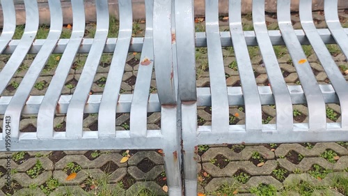 Public bench, blue metal, in the garden.