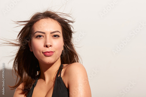 Photos Young white adult woman one person in black bikini portrait with wind blown hair looking at camera indoors studio