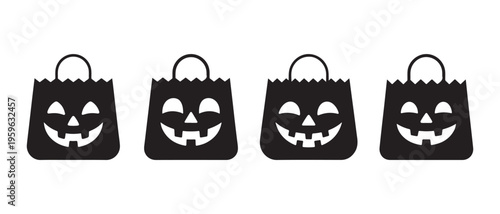 Four black halloween treat bags with jack o lantern faces on a white background.
