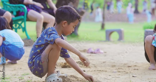 Little school boy enjoy play sand on outdoor playground city park kids relax