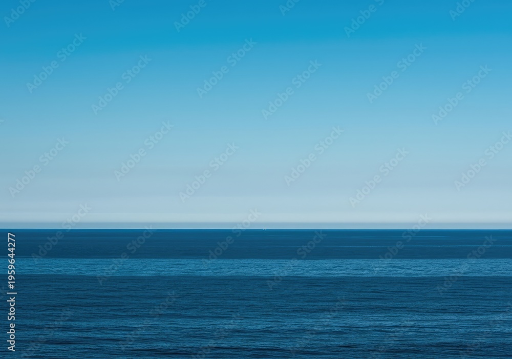 Obraz premium A vast, simple scene showing the meeting point of the calm, deep ocean and the clear, expansive blue sky, creating an ideal minimalist background, open, clear, peaceful