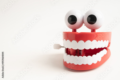 Fotografija Funny red teeth with eye toy denture model for dental health care