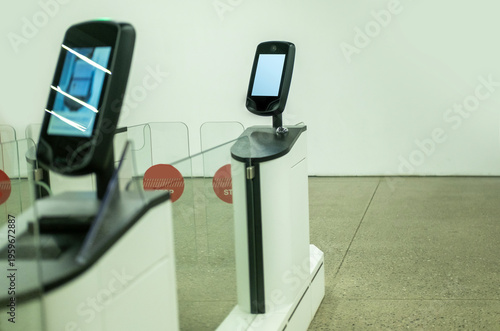 automated passport border control e-gates airport terminal, border crossing point, turnstiles with digital screens and glass barriers, security technology, automated entry systems or public venues