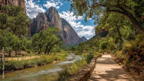 Serene Nature Pathway by River Under Majestic Mountain Peaks
