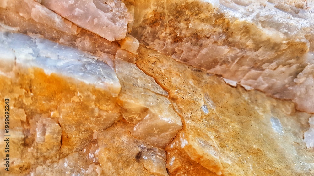Obraz premium Close-up abstract texture of wet raw stalactite cave rock formations with orange and white colors