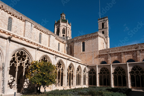 Cloister of Santa Maria de Santes Creus Monastery on sunny day. Tarragona Province, Spain.