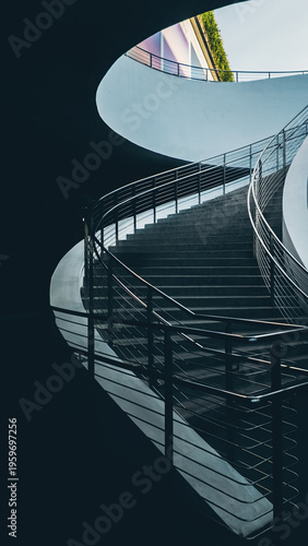 Modern curved staircase with metal railing in minimalist interior architecture, Contemporary concrete stairs with smooth lines and clean design in modern building 4k