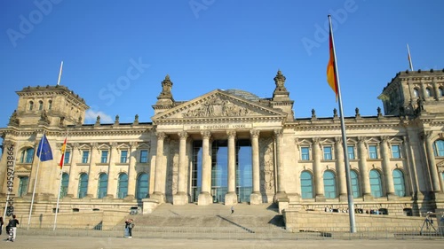 BERLIN, GERMANY - MARCH 23 2026: Panning shot of the historic Reichstag building facade featuring the German national flag and the famous 