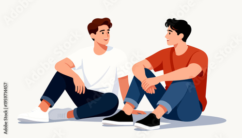 Two young men sit side by side, relaxed and smiling. They chat casually, sharing a friendly, intimate moment. Their posture and expressions suggest comfort and ease. Perfect for stories of friendship