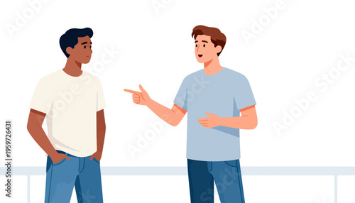 Two men stand facing each other in a plain, bright room. One gestures with his finger while speaking, showing emphasis. The other listens, hands in his pockets, appearing thoughtful