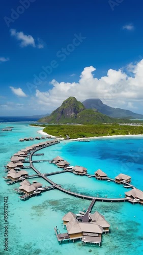 Aerial View of Luxurious Overwater Bungalows Nestled in a Turquoise Lagoon with Lush Tropical Island Backdrop