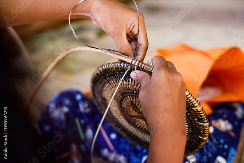 Cuadro en lienzo Hands of Indigenous Mangyan Woman Carefully Weaving a Traditional Basket from Ba