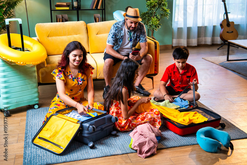 Young Indian parents and children packing bags for a happy family vacation