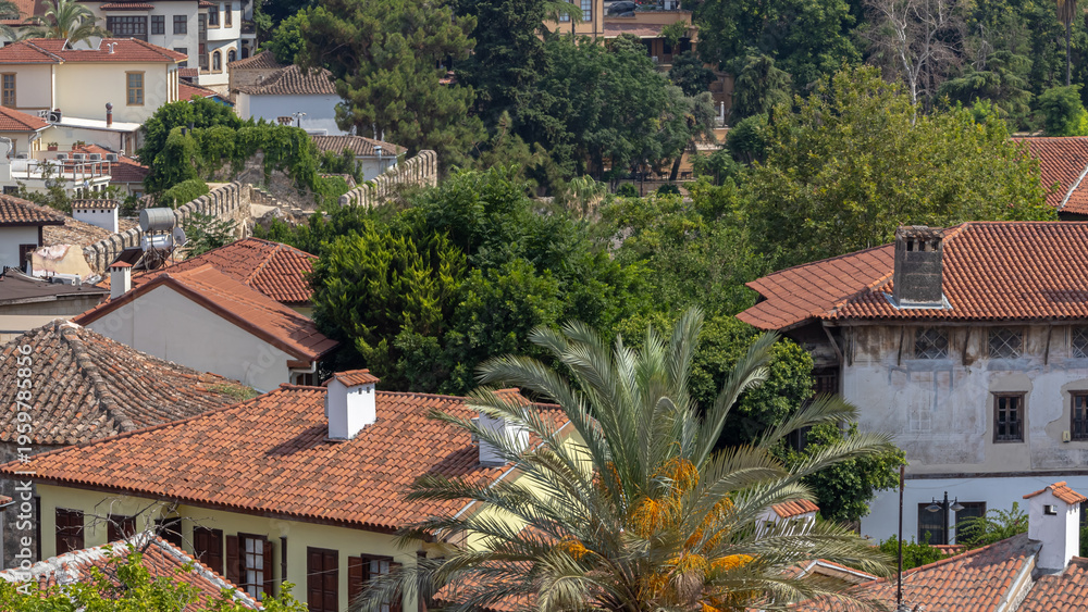 Obraz premium Top view of the tiled roofs of the old town. Kaleici is a quarter in Antalya, located in the Muratpasha district. Historical city center in Antalya. The narrow streets of the old town.