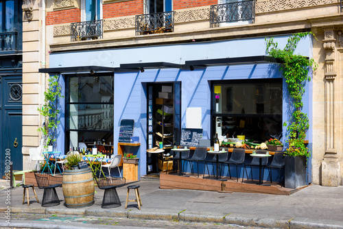 Cozy street with tables of cafe in quarter Montmartre in Paris, France. Architecture and landmarks of Paris. Postcard of Paris