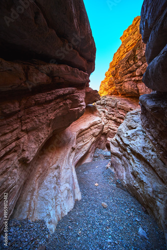Slot Canyon Sunlight and Colorful Rock Formations in Remote Desert Landscape