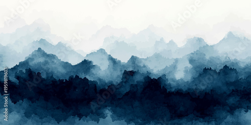Misty mountain landscape featuring forest peaks shrouded in fog and clouds during a blue sunrise over the valley panorama