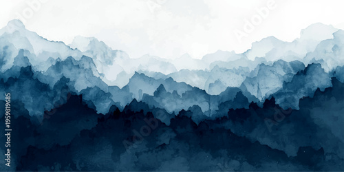 A breathtaking morning view of snow-covered mountains at sunrise where the mist settles over the alpine valley under a soft blue sky