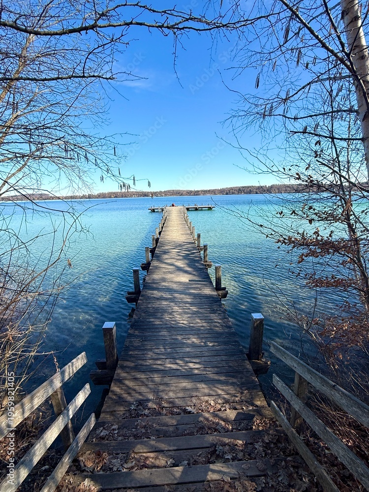 Fototapeta premium long wooden pier over the lake in the morning