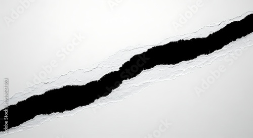 A torn piece of white paper with a black background underneath