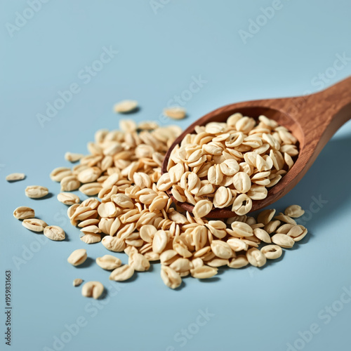 A wooden spoon filled with oats on a blue background