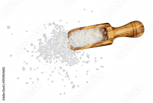 Coarse White Sea Salt Spilling from a Wooden Olive Wood Scoop