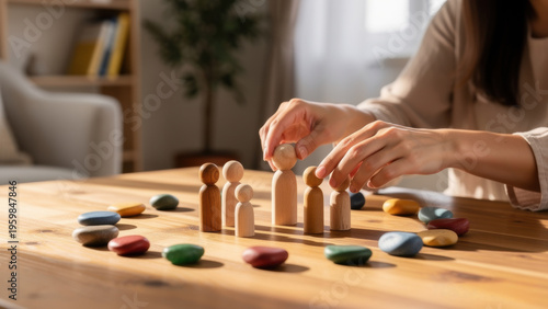 family constellations therapist's hands with small wooden figurines