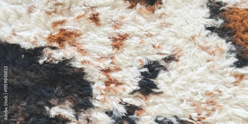 Close up of soft faux fur rug texture with brown black and white patterns