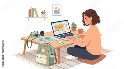 Young woman working on laptop with travel items around her.