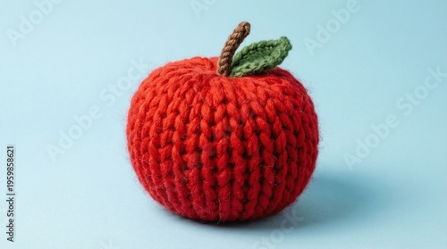 Surreal Concept of a Bright Red Apple Made of Knitted Wool Yarn on Blue Background