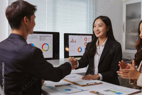 Photos Business professionals finalizing a deal with a handshake, showing collaboration