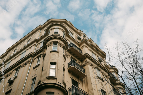 Corner residential building with balconies and decorative elements in Belgrade. Concept of urban living, housing market and European architecture style