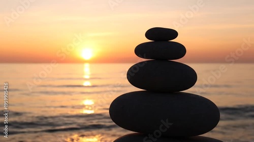 Zen stones on beach at sunset.