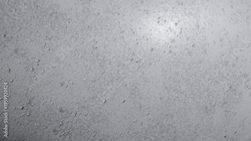 A close up view of a textured light grey surface covered in small scattered water droplets rain