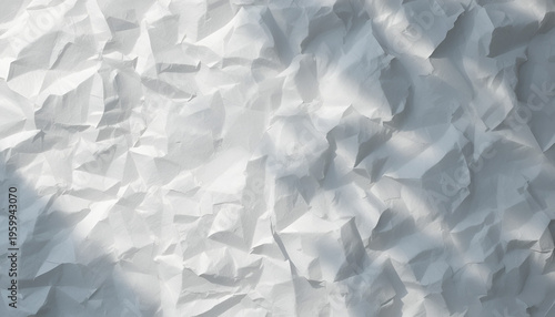 A close-up view of crumpled white paper with textured shadows