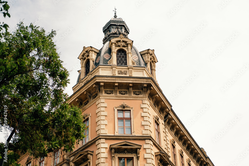 Fototapeta premium Skyward Ornate Corner Tower And Balcony, Urban Vantage, Planner Sketches Facade Restoration, Leafy Tree Frames