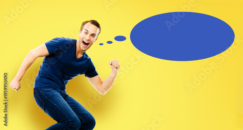 Ideas, inspiration, expressing thoughts, sale ad, enthusiasm, success concept - young man jump run with raised hand fist, open-mouthed smile, isolate yellow background. Blue empty think speech bubble