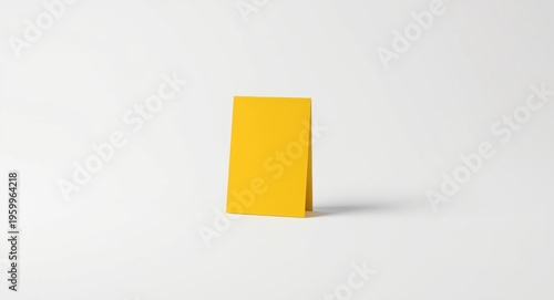 Bright yellow jotter pad on an empty plain backdrop
