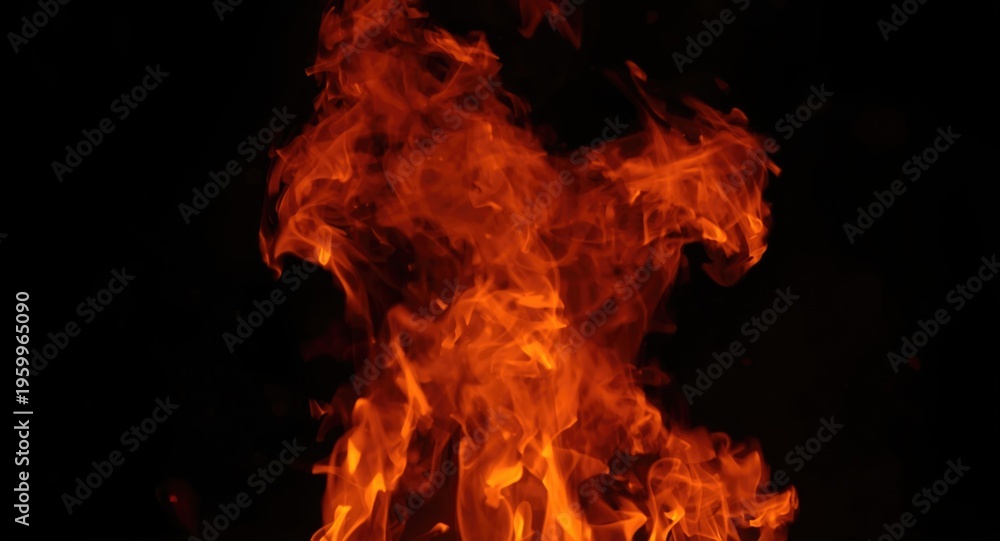Fototapeta premium Red flames burning brightly with natural motion during night