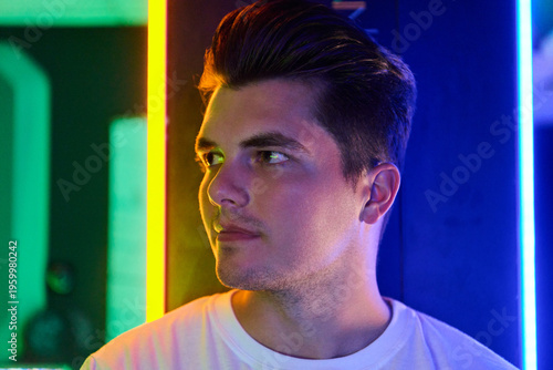 Young Man Portrait in Neon Light Looking Sideways With Modern Nightlife Vibe