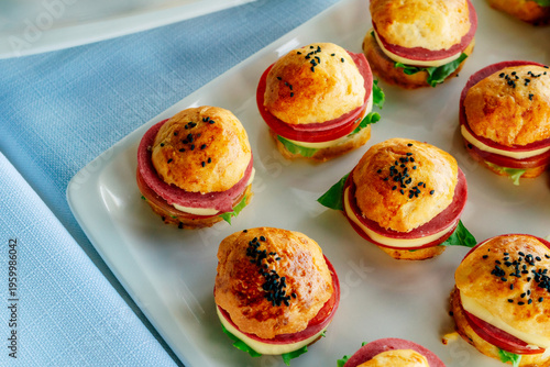 Beautifully Arranged Tiny Savory Sandwiches Presented On Vibrant Linen Cloth