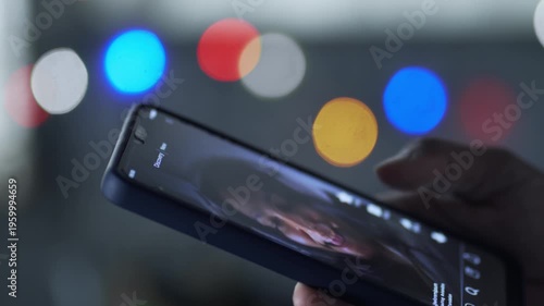 Finger scrolling through social media feed on smartphone at night