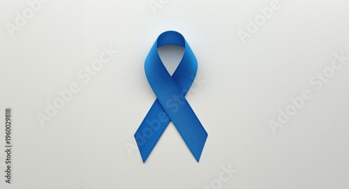 Health awareness blue ribbon for colorectal juvenile arthritis and tuberous sclerosis displayed on simple textured background