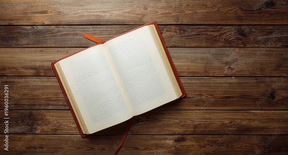 Fototapeta premium Birds eye perspective of open blank book on aged wooden tabletop