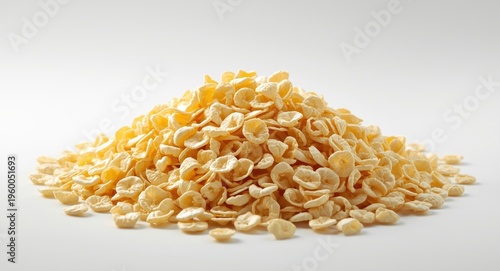 Heap of fresh looking corn flakes in white and yellow on an isolated background scene