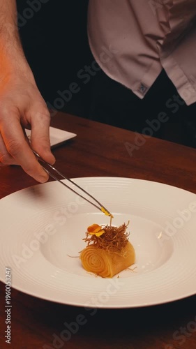 dishes of haute cuisine presentation serving details in dishes. chef hands put greens flowers sauce on plate. close up white plate in restaurant. food in Michelin restaurant. modern cooking technology