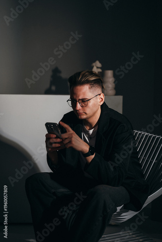 White male engaged with his phone in professional setting