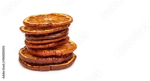 Isolated dried citrus slices with seeds stacked against a white background