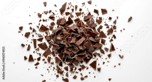 Dynamic display of chocolate shards breaking on a pristine white flat surface